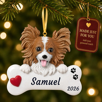 Papillon Dog Bone christmas ornament hanging on a lit Christmas tree with a Made Just For You gift tag