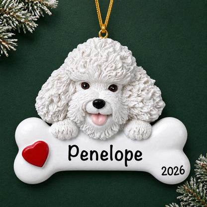 Personalized Bichon Frise dog bone Christmas ornament, engraved with a name and year, on a green holiday backdrop
