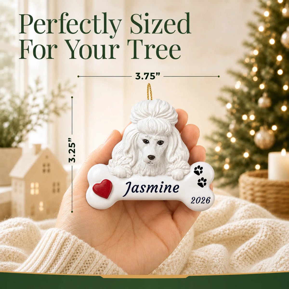 Size guide: the personalized White Poodle Dog Bone christmas ornament is 3.75 in wide by 3.25 in tall, shown in hand