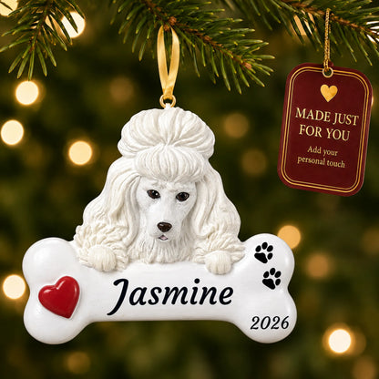 White Poodle Dog Bone christmas ornament hanging on a lit Christmas tree with a Made Just For You gift tag