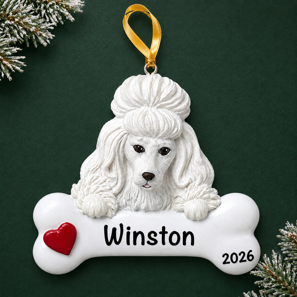 Personalized white poodle dog bone Christmas ornament, engraved with a name and year, on a green holiday backdrop