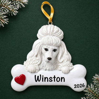 Personalized white poodle dog bone Christmas ornament, engraved with a name and year, on a green holiday backdrop