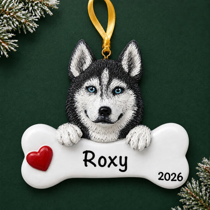 Personalized Siberian husky dog bone Christmas ornament, engraved with a name and year, on a green holiday backdrop