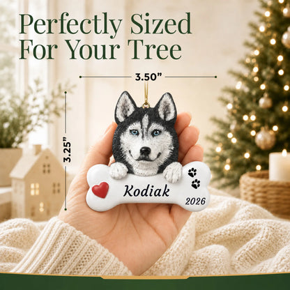 Hand holding the personalized Siberian husky Christmas ornament to show its 3.50 inch width