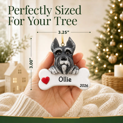 Hand holding the personalized schnauzer Christmas ornament to show its 3.25 inch width