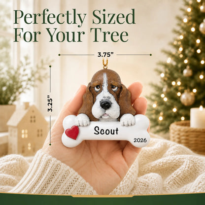 Hand holding the personalized basset hound Christmas ornament to show its 3.75 inch width