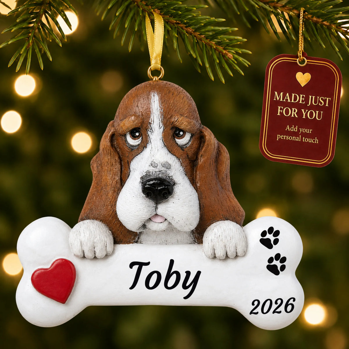 Basset Hound Dog Bone christmas ornament hanging on a lit Christmas tree with a Made Just For You gift tag