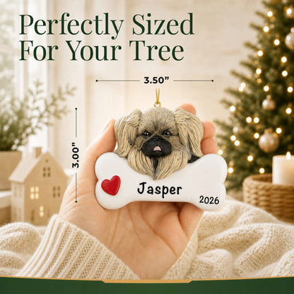 Hand holding the personalized Pekingese Christmas ornament to show its 3.50 inch width