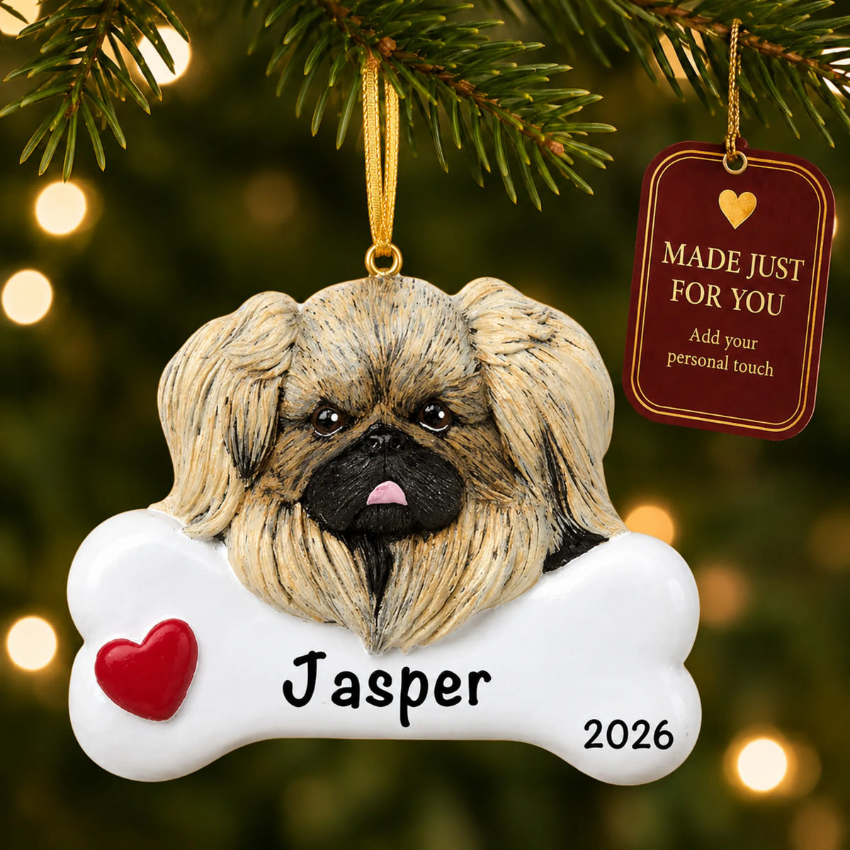 Personalized Pekingese Christmas ornament hanging on a lit tree beside a Made Just For You tag