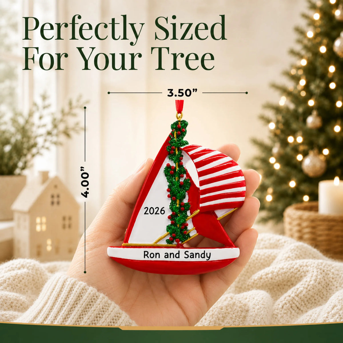 Size guide: the personalized red sailboat christmas ornament is 3.50 in wide by 4.00 in tall, shown in hand