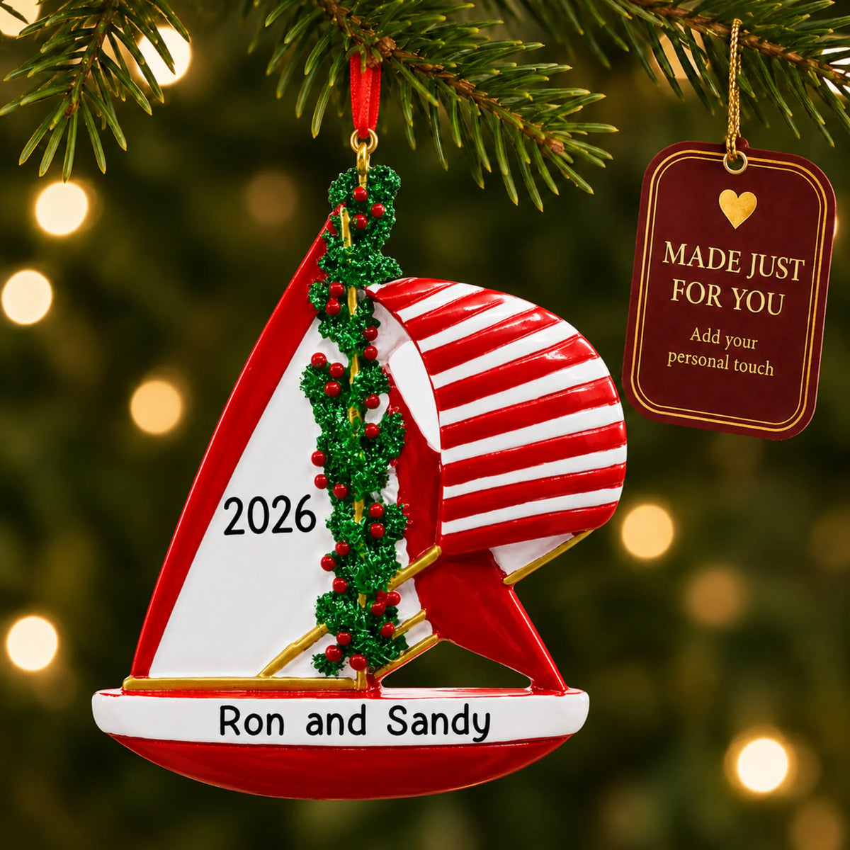 Red sailboat christmas ornament hanging on a lit Christmas tree with a Made Just For You gift tag