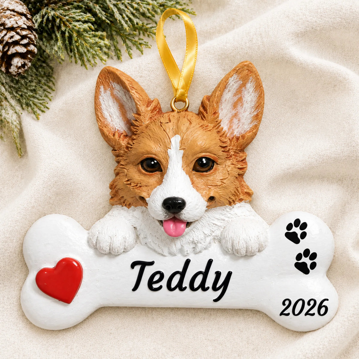 Personalized Corgi Dog Bone christmas ornament laid on a soft white knit blanket