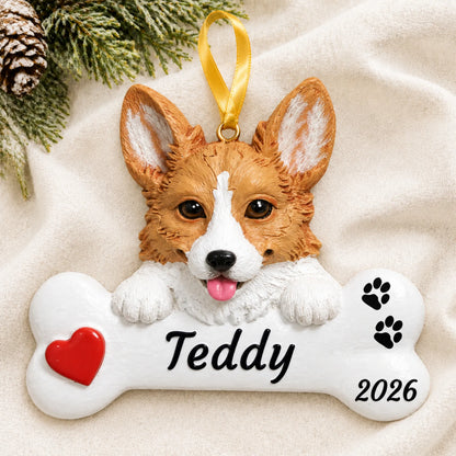 Personalized Corgi Dog Bone christmas ornament laid on a soft white knit blanket