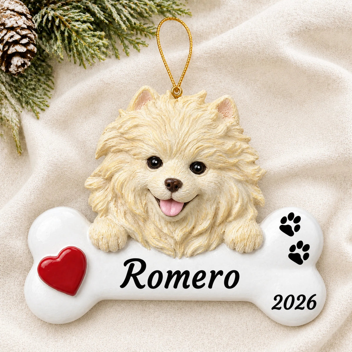Personalized Pomeranian Dog Bone christmas ornament laid on a soft white knit blanket