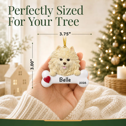 Hand holding the personalized Pomeranian Christmas ornament to show its 3.75 inch width