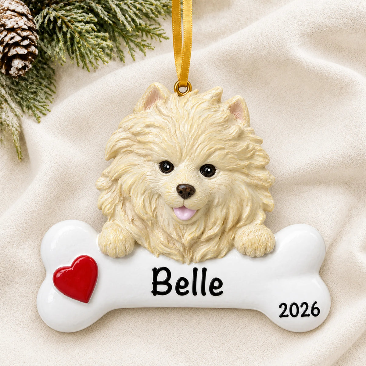 Personalized Pomeranian dog bone Christmas ornament resting on a soft white blanket with pine and pinecones
