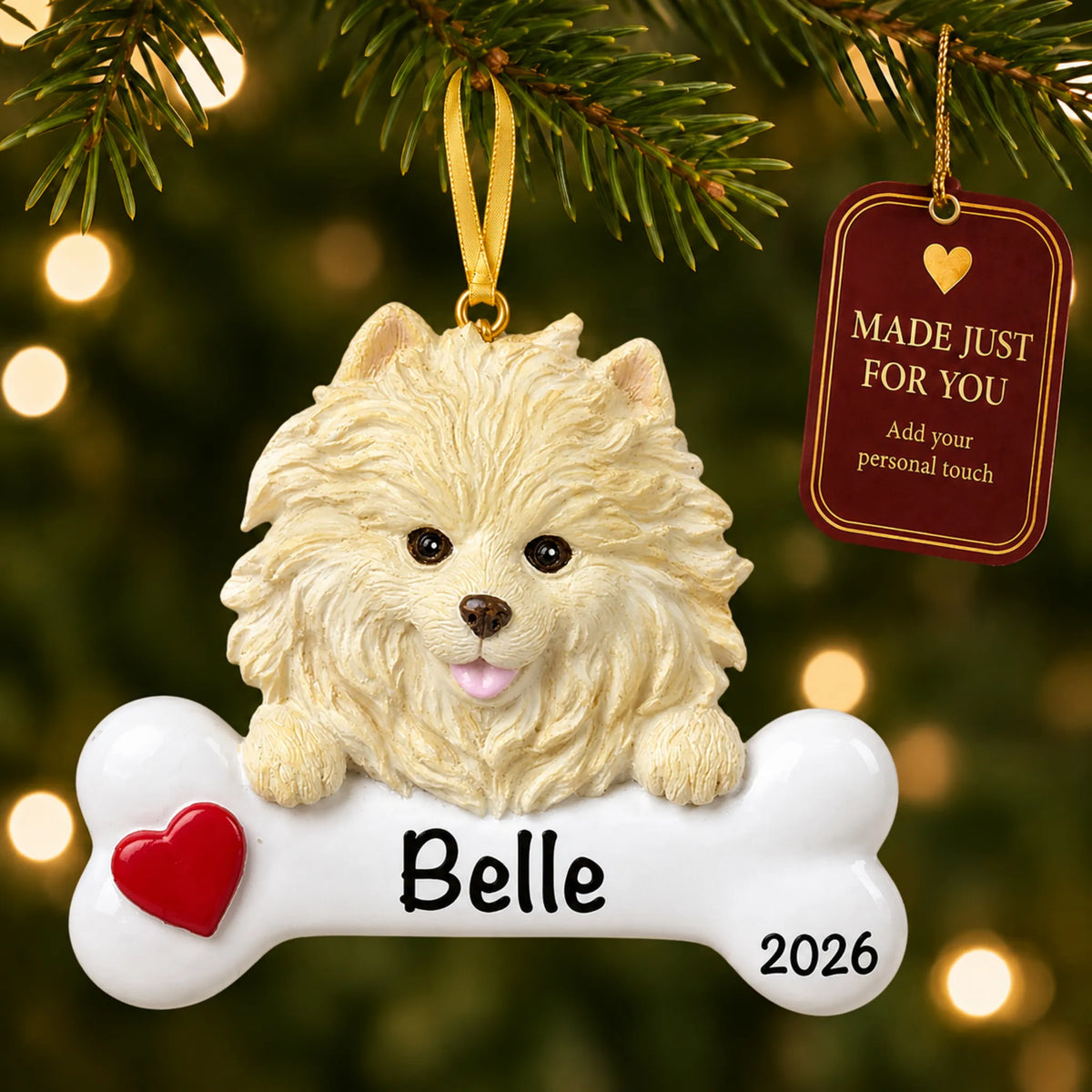 Personalized Pomeranian Christmas ornament hanging on a lit tree beside a Made Just For You tag