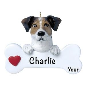 Personalized Jack Russell Christmas ornament, the dog resting its head and paws on a white dog bone with a red heart, the pet name laser engraved across the bone and the year below it