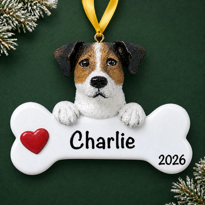 Personalized Jack Russell dog bone Christmas ornament, engraved with a name and year, on a green holiday backdrop