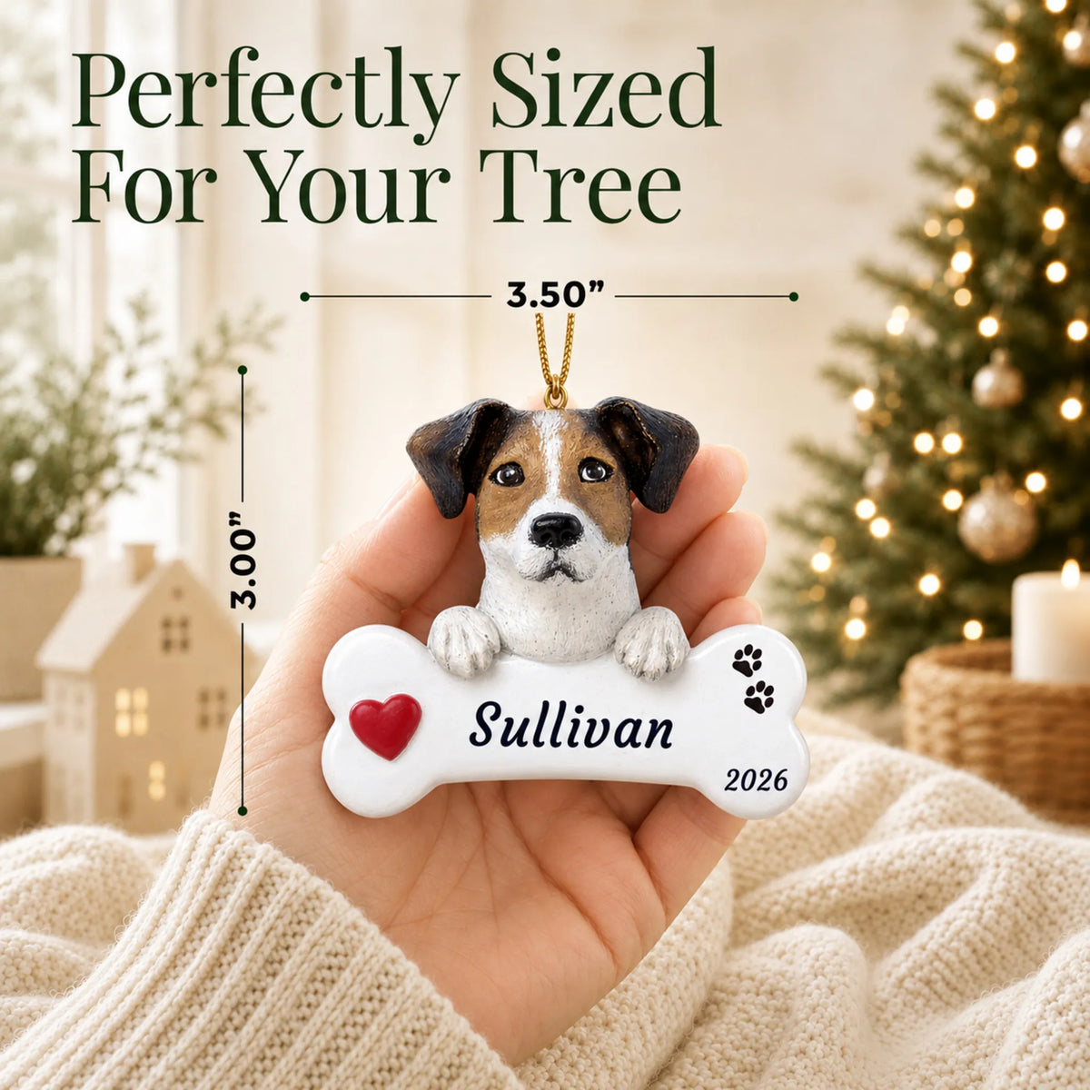 Size guide: the personalized Jack Russell Dog Bone christmas ornament is 3.50 in wide by 3.00 in tall, shown in hand
