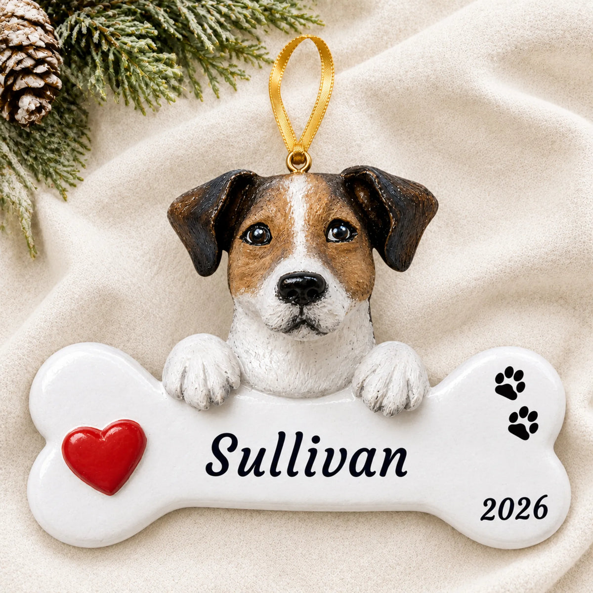 Personalized Jack Russell Dog Bone christmas ornament laid on a soft white knit blanket