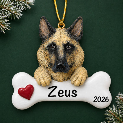 Personalized German shepherd dog bone Christmas ornament, engraved with a name and year, on a green holiday backdrop