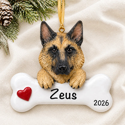 Personalized German shepherd dog bone Christmas ornament resting on a soft white blanket with pine and pinecones