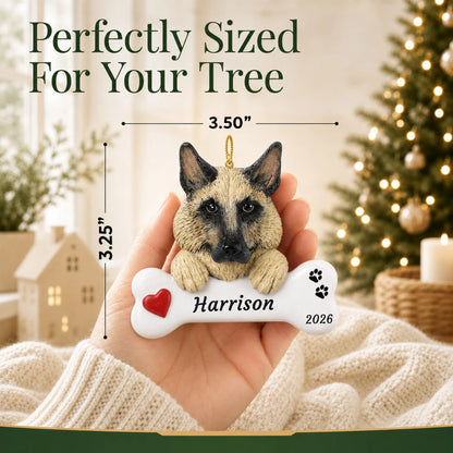 Size guide: the personalized German Shepherd Dog Bone christmas ornament is 3.50 in wide by 3.25 in tall, shown in hand