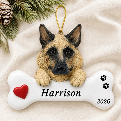 Personalized German Shepherd Dog Bone christmas ornament laid on a soft white knit blanket
