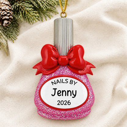 Personalized nail polish bottle nail tech christmas ornament laid on a soft white knit blanket