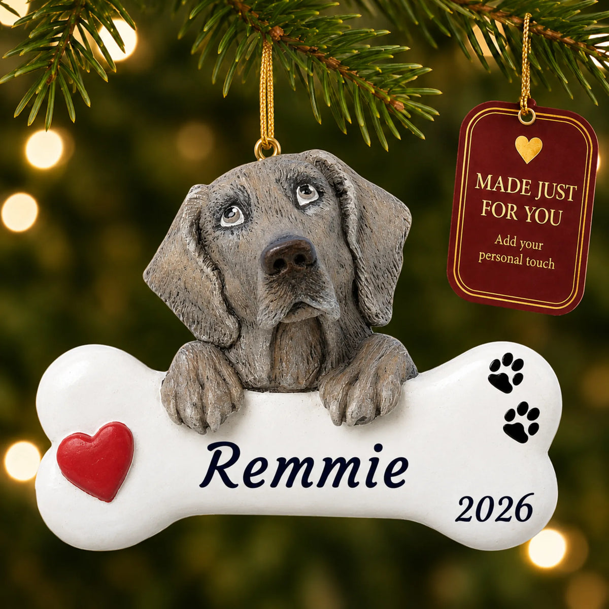 Weimaraner Dog Bone christmas ornament hanging on a lit Christmas tree with a Made Just For You gift tag