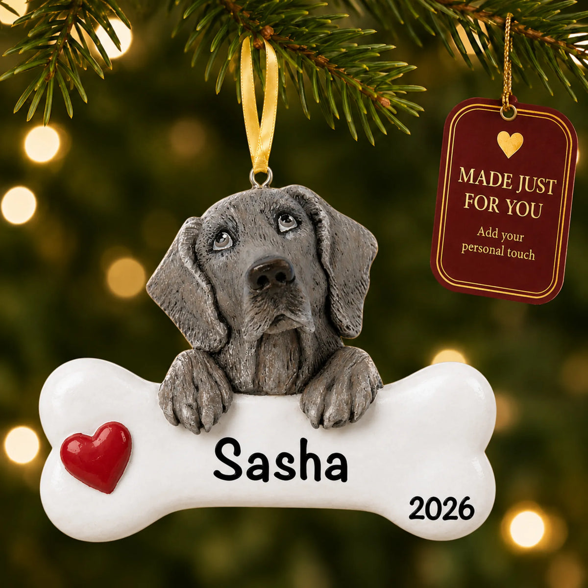 Personalized Weimaraner Christmas ornament hanging on a lit tree beside a Made Just For You tag