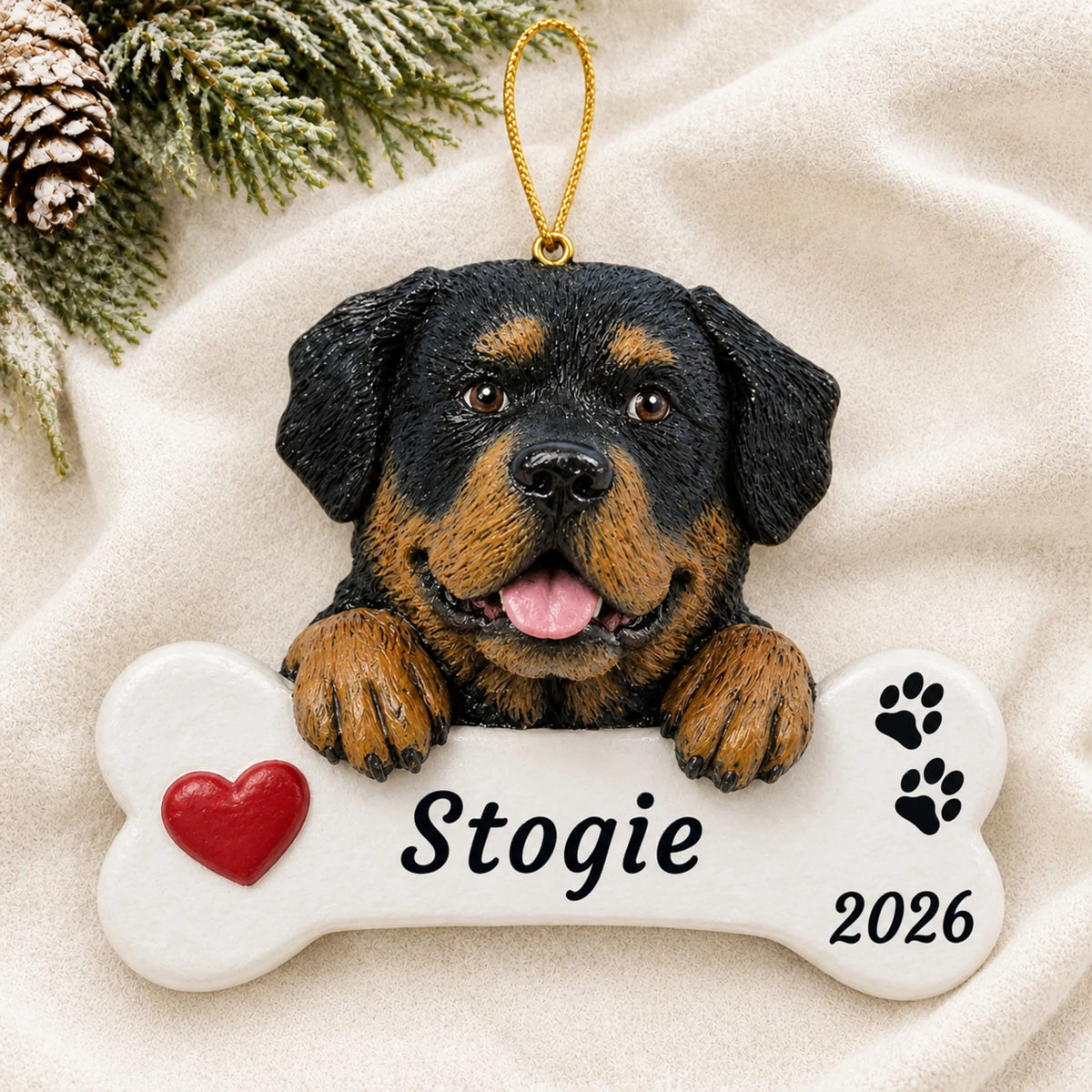 Personalized Rottweiler Dog Bone christmas ornament laid on a soft white knit blanket