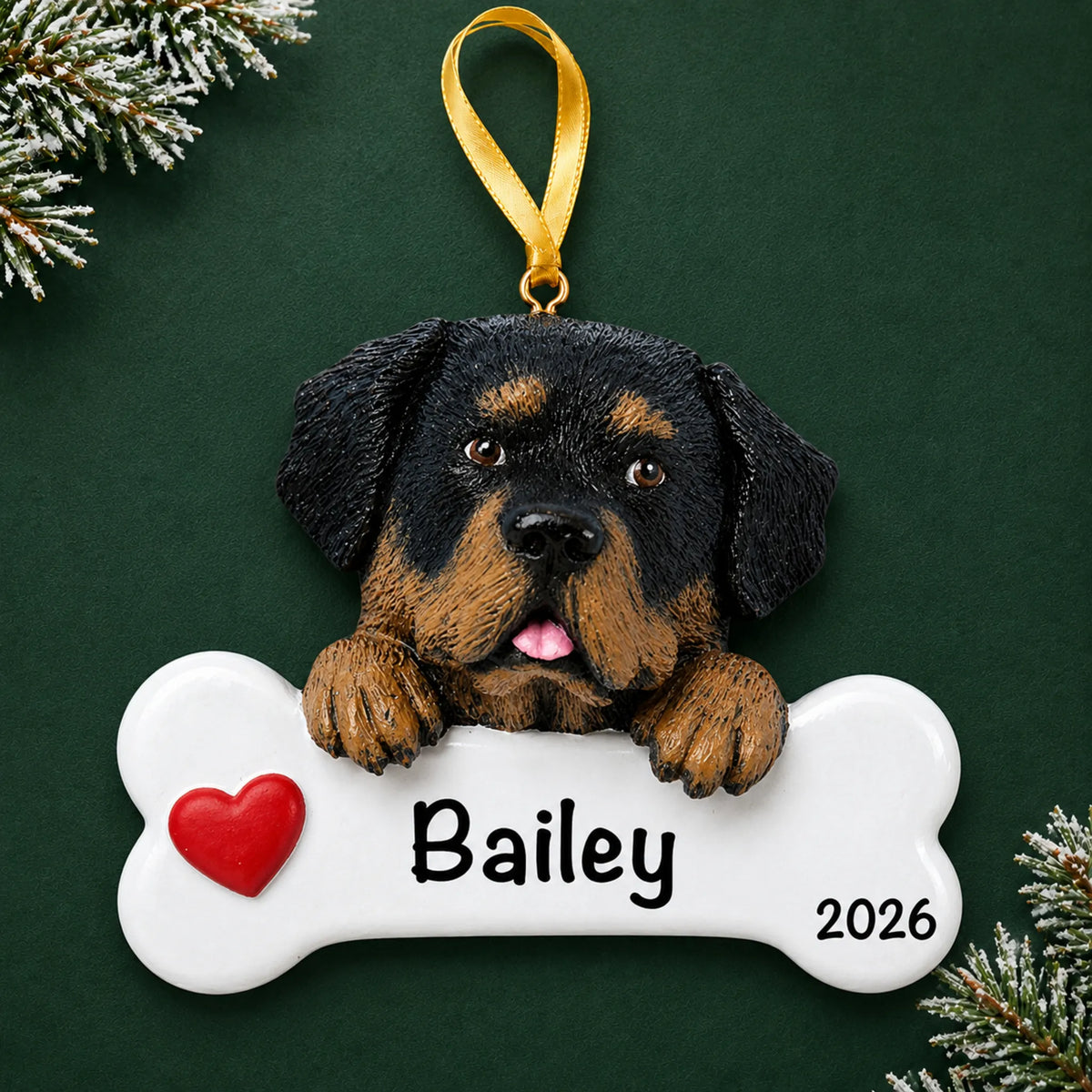 Personalized Rottweiler dog bone Christmas ornament, engraved with a name and year, on a green holiday backdrop