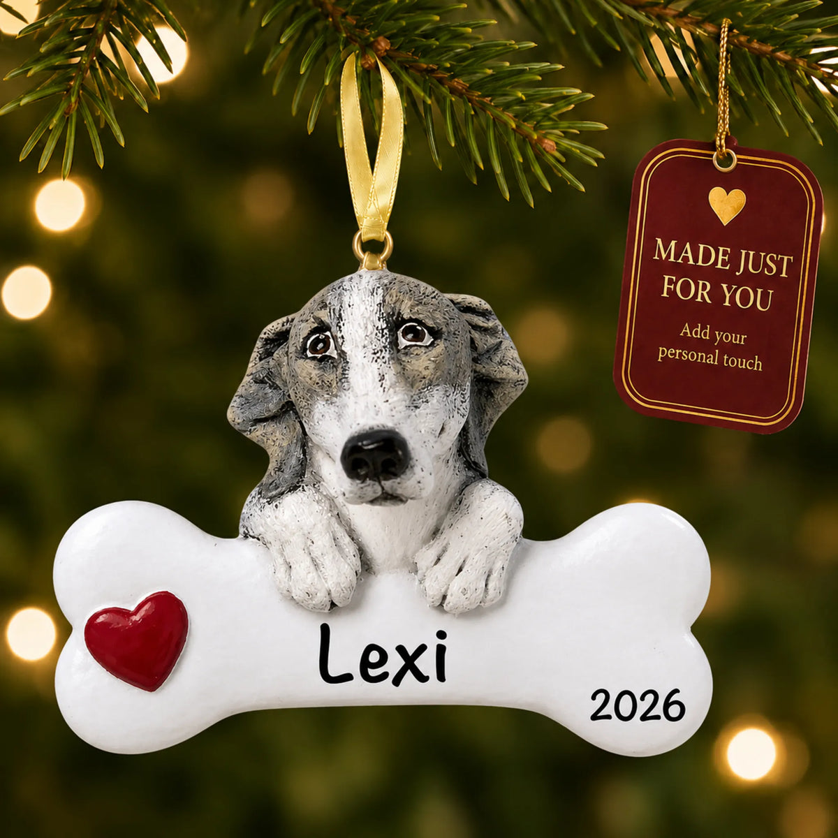 Personalized greyhound Christmas ornament hanging on a lit tree beside a Made Just For You tag