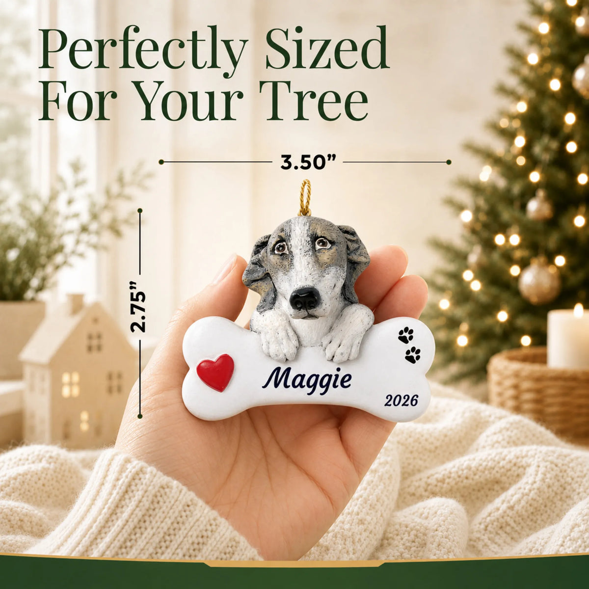 Size guide: the personalized Greyhound Dog Bone christmas ornament is 3.50 in wide by 2.75 in tall, shown in hand