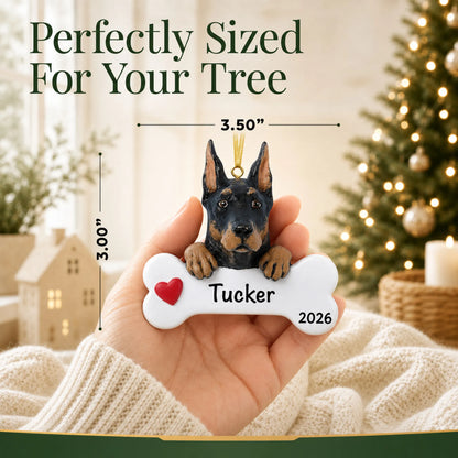 Hand holding the personalized Doberman pinscher Christmas ornament to show its 3.50 inch width