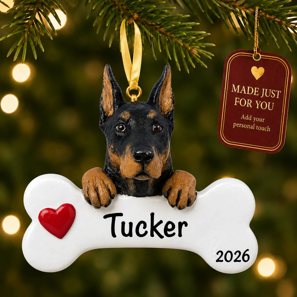 Personalized Doberman pinscher Christmas ornament hanging on a lit tree beside a Made Just For You tag