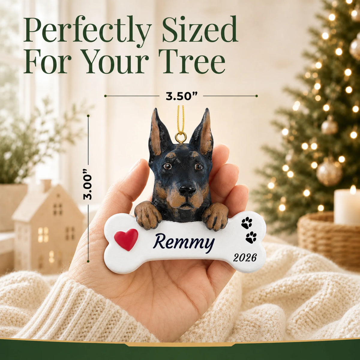 Size guide: the personalized Doberman Pinscher Dog Bone christmas ornament is 3.50 in wide by 3.00 in tall, shown in hand