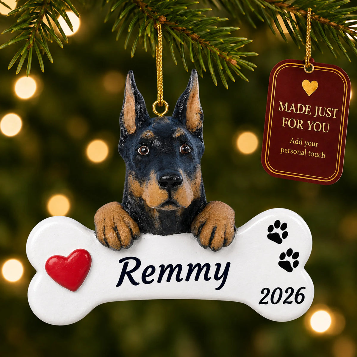Doberman Pinscher Dog Bone christmas ornament hanging on a lit Christmas tree with a Made Just For You gift tag