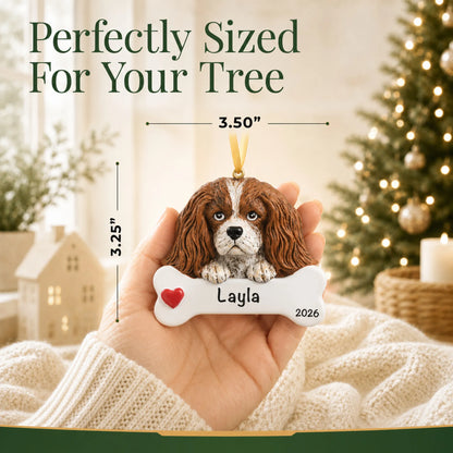 Hand holding the personalized King Charles Cavalier Christmas ornament to show its 3.50 inch width