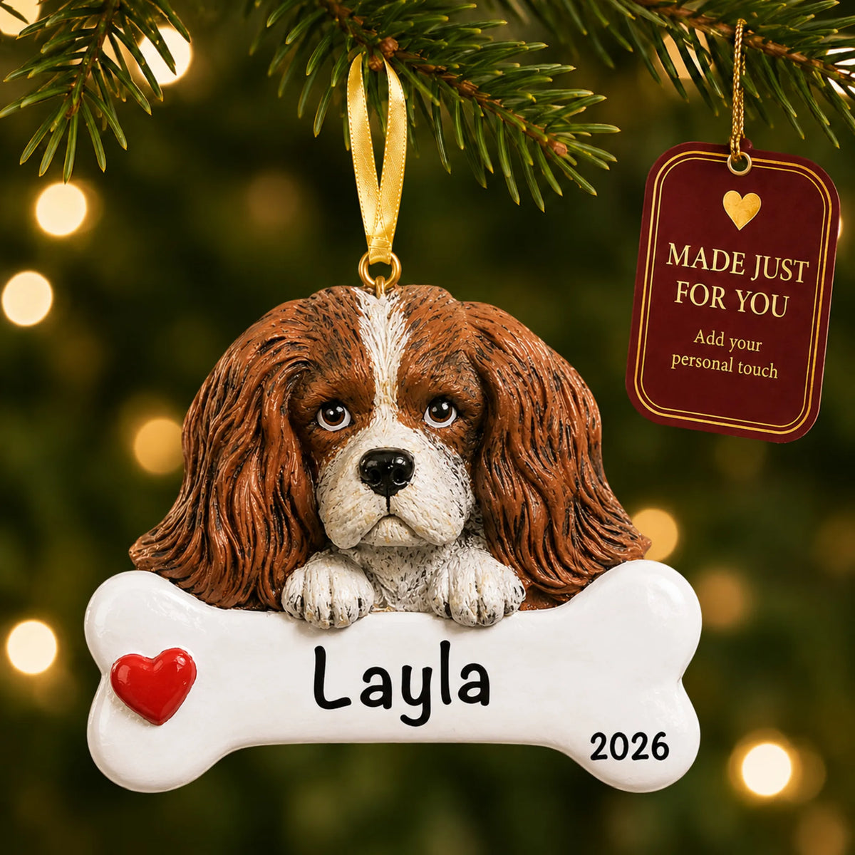 Personalized King Charles Cavalier Christmas ornament hanging on a lit tree beside a Made Just For You tag