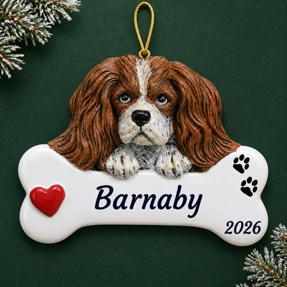 Personalized King Charles Cavalier Dog Bone christmas ornament on a dark green pine background