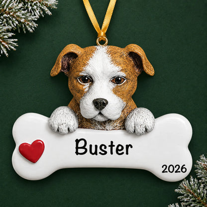 Personalized Staffordshire pit bull dog bone Christmas ornament, engraved with a name and year, on a green holiday backdrop