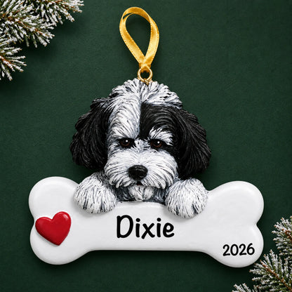 Personalized Havanese dog bone Christmas ornament, engraved with a name and year, on a green holiday backdrop