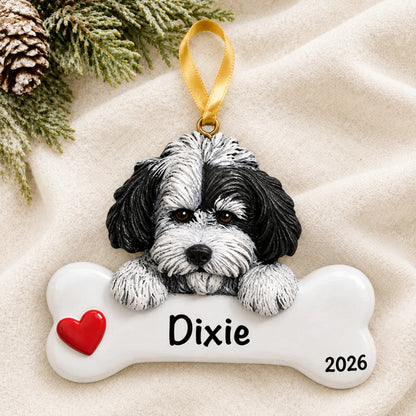 Personalized Havanese dog bone Christmas ornament resting on a soft white blanket with pine and pinecones