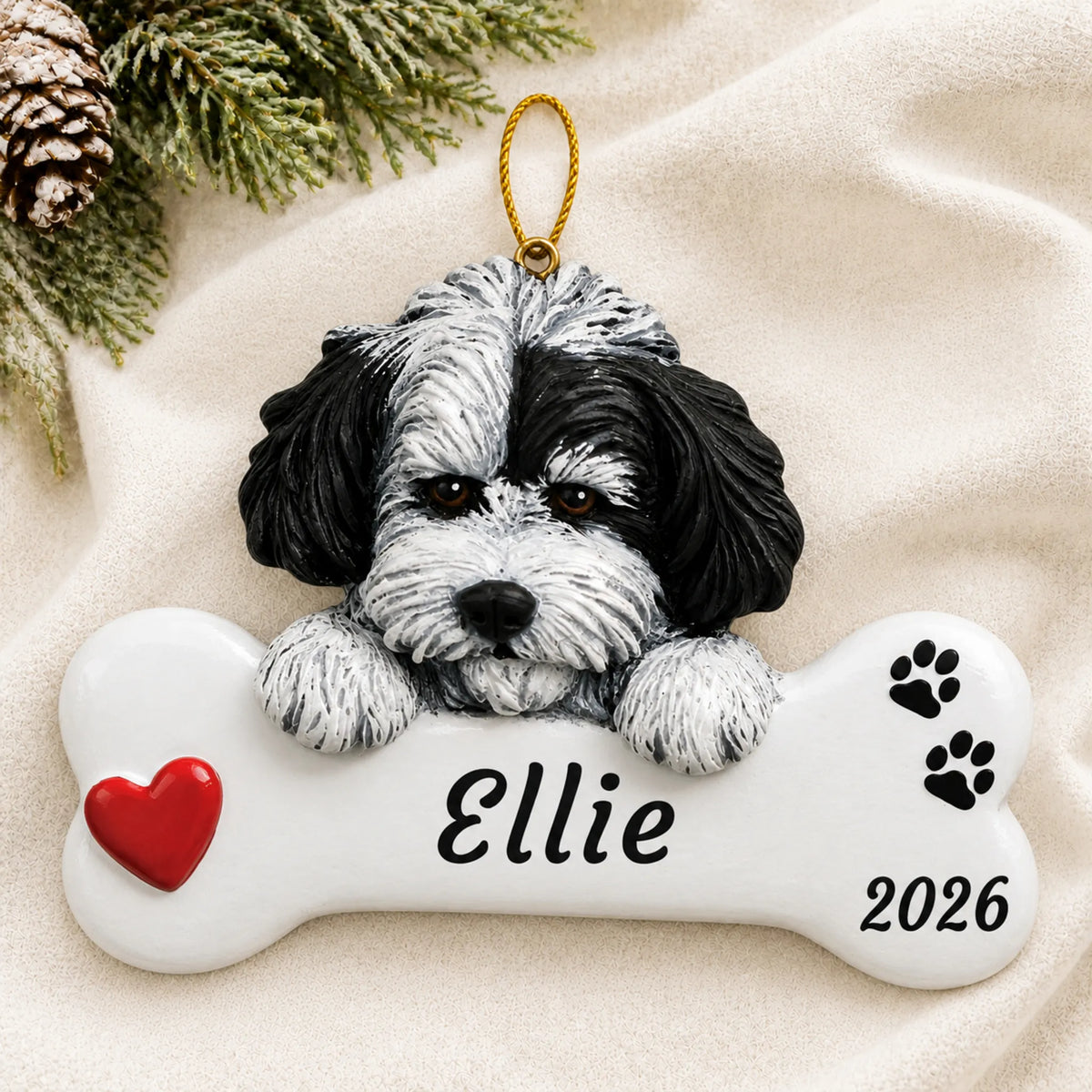 Personalized Havanese Dog Bone christmas ornament laid on a soft white knit blanket