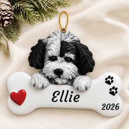 Personalized Havanese Dog Bone christmas ornament laid on a soft white knit blanket