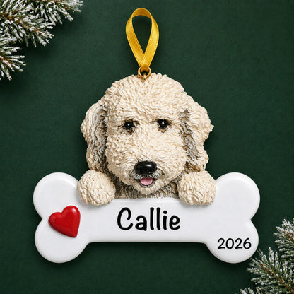 Personalized Labradoodle dog bone Christmas ornament, engraved with a name and year, on a green holiday backdrop