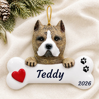 Personalized Pit Bull Dog Bone christmas ornament laid on a soft white knit blanket